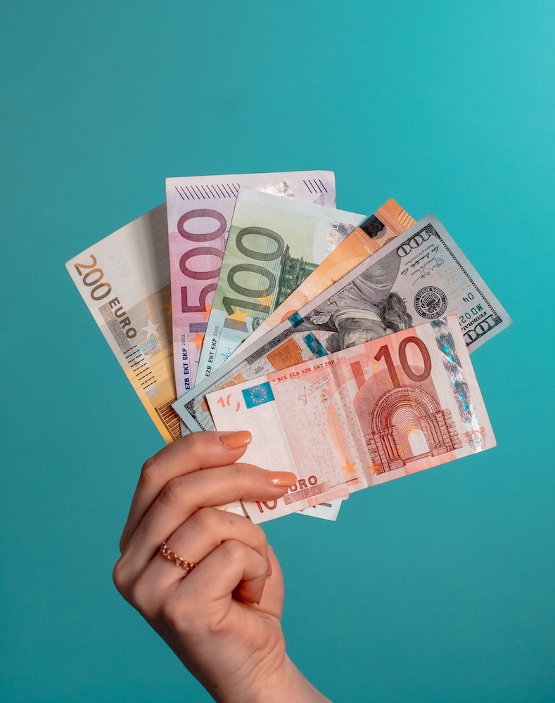 hand holding dollars and euros